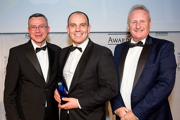 Zak McElvenny Group Compliance & Standards Manager is seen receiving the award on behalf of the company.